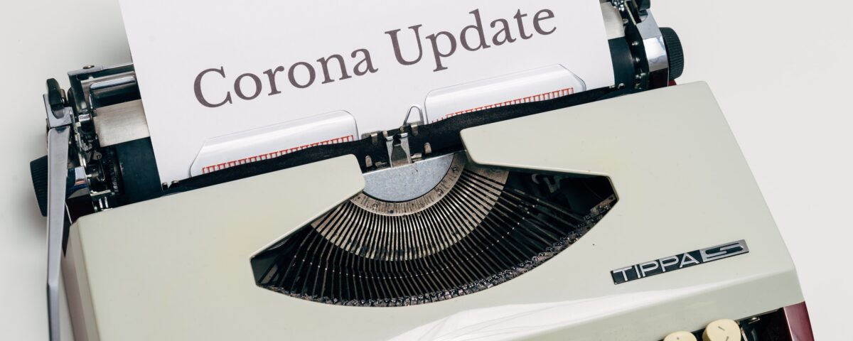 Typewriter printing "Corona Update" on paper